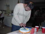 Click to see Ken cutting cake.jpg